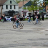 Police Officer's from Cleveland's 2nd District watch as neighborhood children enjoy the comfortable weather during the bike-a-thon.